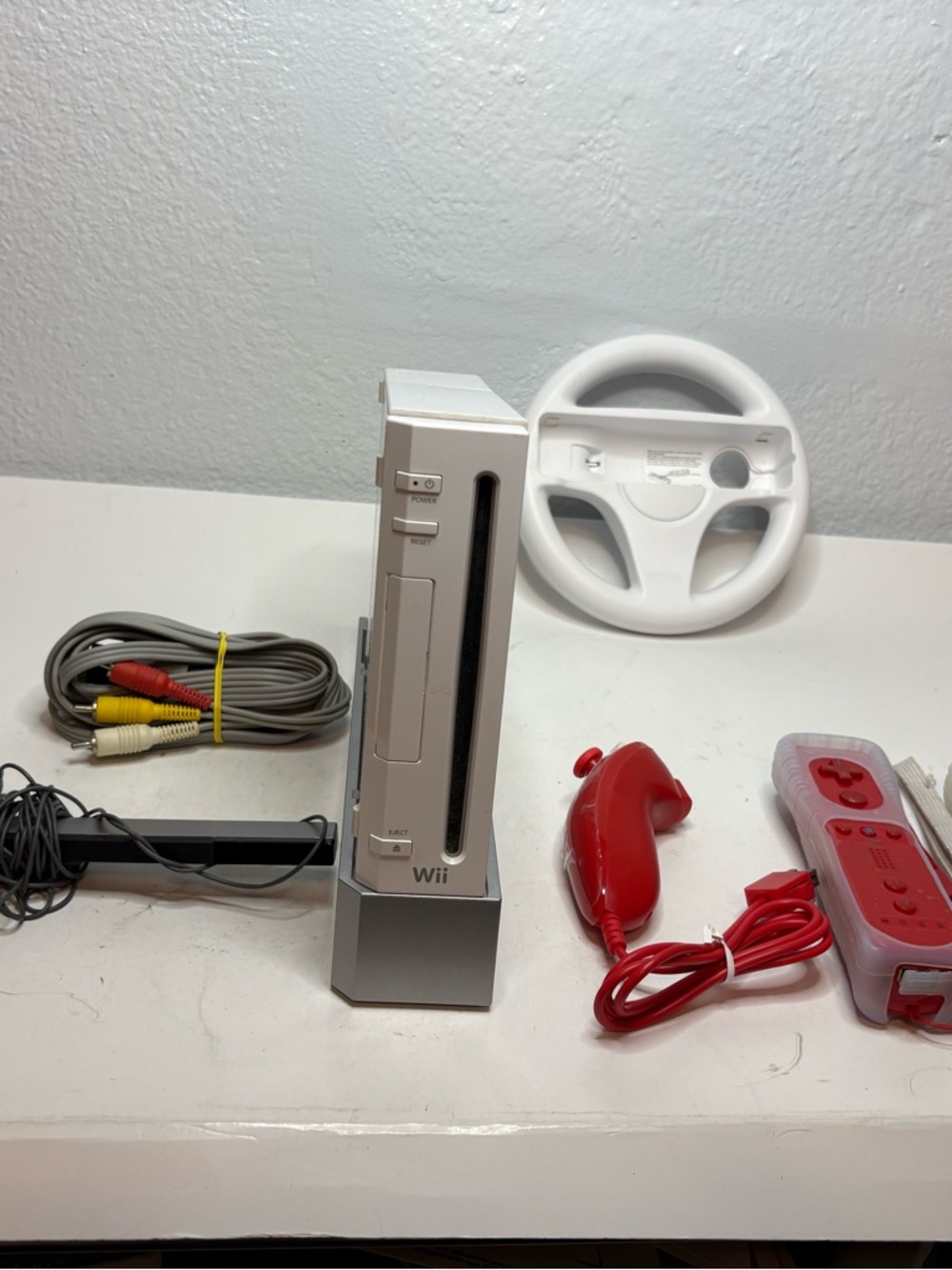 Nintendo White Wii Console with Red Remotes and Wheel